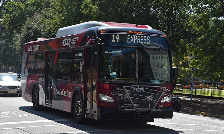 A photo of a garnet and black USC bus.”